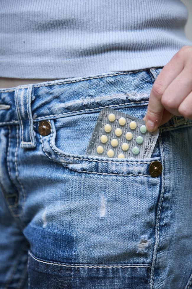 Birth control pill pack from Planned Parenthood Direct in front jean pocket